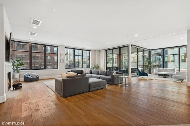 1109 W Washington Blvd Unit 2B, Chicago, IL 60607 - living room with hardwood / wood-style floors, plenty of natural light, a fireplace, recessed lighting, and floor to ceiling windows