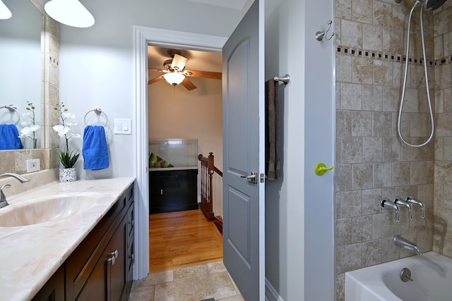 7701 New Castle Ave, Burbank, IL 60459 - full bathroom with vanity, tub / shower combination, stone finish flooring, and a ceiling fan