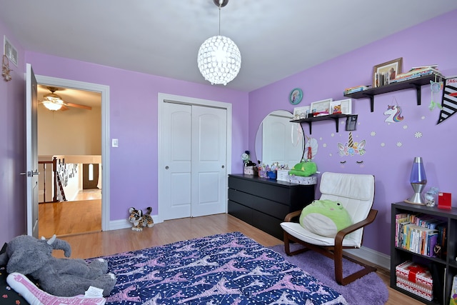 7701 New Castle Ave, Burbank, IL 60459 - bedroom featuring wood finished floors, a chandelier, a closet, and baseboards