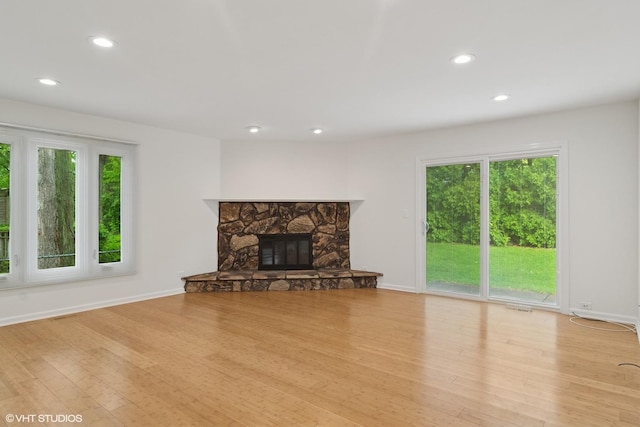 1118 W Keating Dr, Arlington Heights, IL 60005 - unfurnished living room with recessed lighting, wood finished floors, baseboards, and a stone fireplace