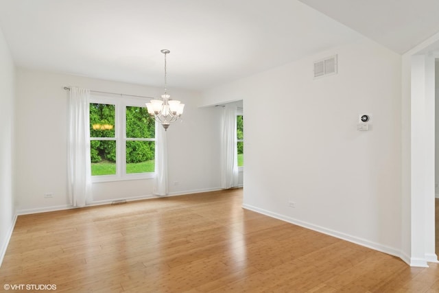 1118 W Keating Dr, Arlington Heights, IL 60005 - spare room with a chandelier, light wood-type flooring, and baseboards
