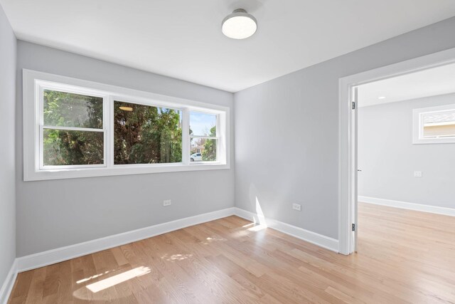 44 Cranbrook Dr, Des Plaines, IL 60016 - spare room featuring healthy amount of natural light, light wood-type flooring, and baseboards