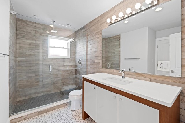44 Cranbrook Dr, Des Plaines, IL 60016 - bathroom with toilet, a shower stall, vanity, and tile walls