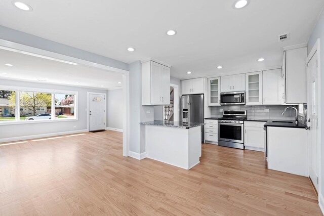 44 Cranbrook Dr, Des Plaines, IL 60016 - kitchen with stainless steel appliances, a sink, recessed lighting, white cabinets, and light wood-type flooring