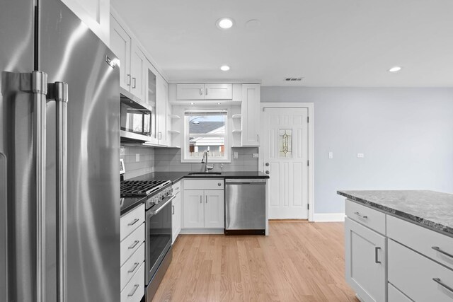 44 Cranbrook Dr, Des Plaines, IL 60016 - kitchen featuring high end appliances, a sink, open shelves, recessed lighting, and tasteful backsplash