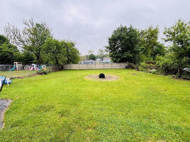 484 Hickory Pl, Elgin, IL 60120 - view of yard featuring an outdoor fire pit and a playground
