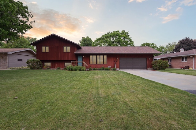 608 E Webster St, Polo, IL 61064 - split level home featuring a garage, concrete driveway, and a lawn