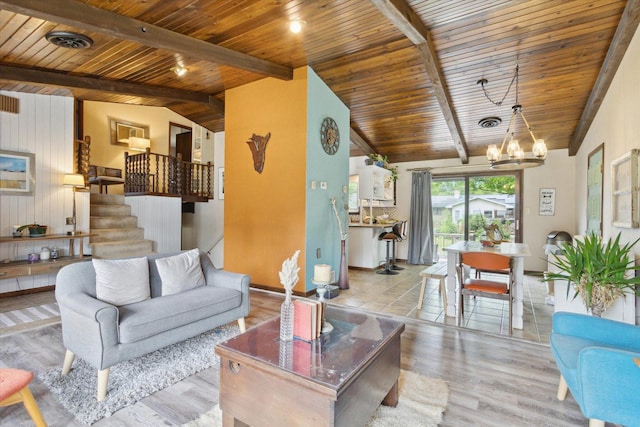 608 E Webster St, Polo, IL 61064 - living room featuring wooden ceiling, a chandelier, wood finished floors, stairs, and baseboards