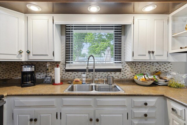 608 E Webster St, Polo, IL 61064 - kitchen with a sink, white cabinets, and tasteful backsplash