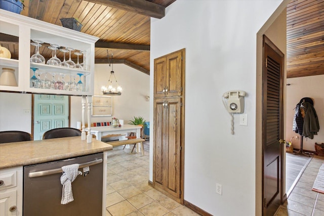 608 E Webster St, Polo, IL 61064 - kitchen with stainless steel dishwasher, wooden ceiling, light tile patterned flooring, a chandelier, and light countertops