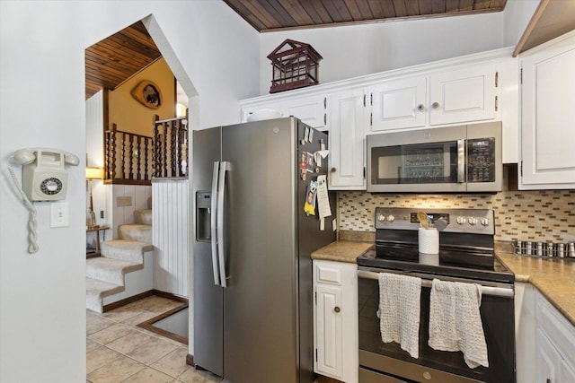 608 E Webster St, Polo, IL 61064 - kitchen with stainless steel appliances, white cabinets, tasteful backsplash, wood ceiling, and light tile patterned floors