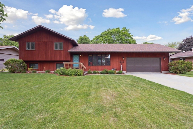 608 E Webster St, Polo, IL 61064 - tri-level home with concrete driveway, a garage, and a front lawn