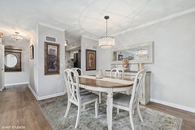 565 Shorely Dr Unit 202, Barrington, IL 60010 - dining area featuring wood finished floors, baseboards, a chandelier, and ornamental molding
