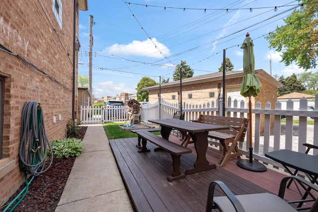 5855 W Higgins Ave Unit Gr, Chicago, IL 60630 - deck featuring outdoor dining area and fence