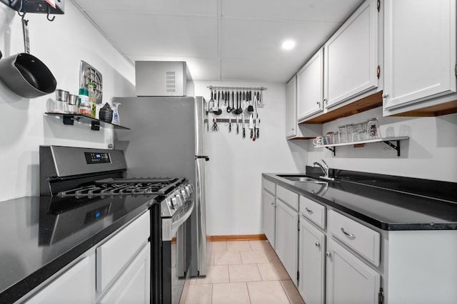 5855 W Higgins Ave Unit Gr, Chicago, IL 60630 - kitchen featuring stainless steel gas range, a sink, dark countertops, and white cabinetry