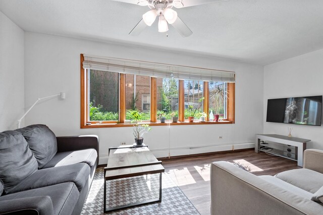 5855 W Higgins Ave Unit Gr, Chicago, IL 60630 - living room with wood finished floors, a ceiling fan, and baseboards