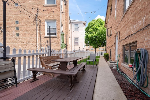 5855 W Higgins Ave Unit Gr, Chicago, IL 60630 - wooden deck featuring outdoor dining space and fence