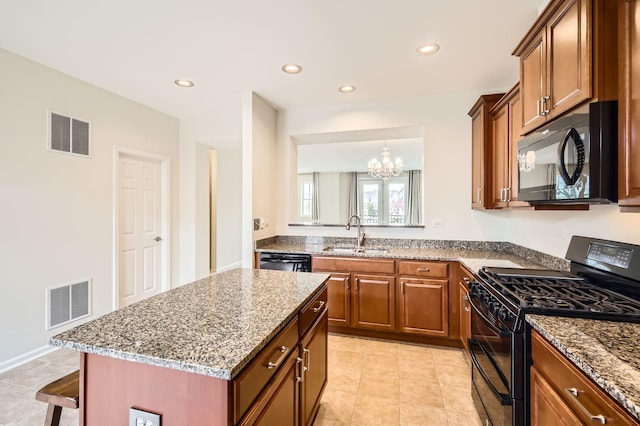 203 W Hyde St, Arlington Heights, IL 60005 - kitchen featuring black appliances, a sink, a chandelier, a breakfast bar, and stone countertops