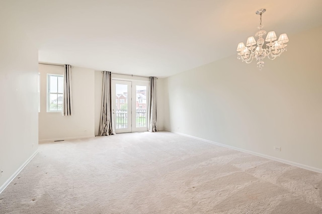 203 W Hyde St, Arlington Heights, IL 60005 - empty room featuring a chandelier, light carpet, and baseboards