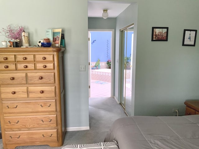 carpeted bedroom with access to outside and baseboards