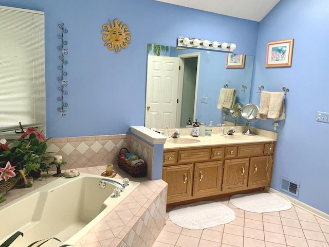 bathroom with tile patterned flooring, a bath, and double vanity