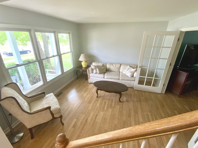 living area with wood finished floors and baseboards