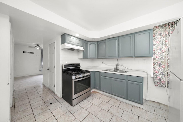 4446 S Wood St, Chicago, IL 60609 - kitchen with stainless steel range with gas cooktop, a sink, backsplash, light countertops, and under cabinet range hood