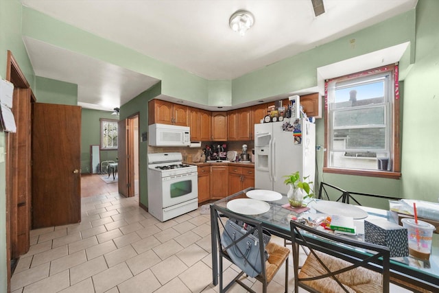 4446 S Wood St, Chicago, IL 60609 - kitchen featuring white appliances, healthy amount of natural light, brown cabinetry, and light tile patterned floors