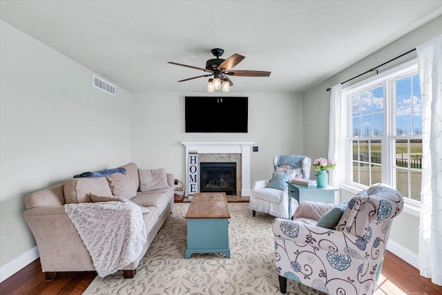 31 Lodge Trl, Monticello, IL 61856 - living area with a ceiling fan, light wood-style flooring, baseboards, and a glass covered fireplace