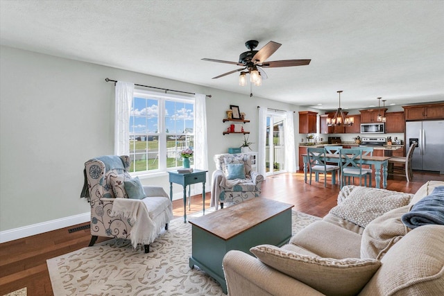 31 Lodge Trl, Monticello, IL 61856 - living area featuring baseboards, ceiling fan, wood finished floors, and a chandelier