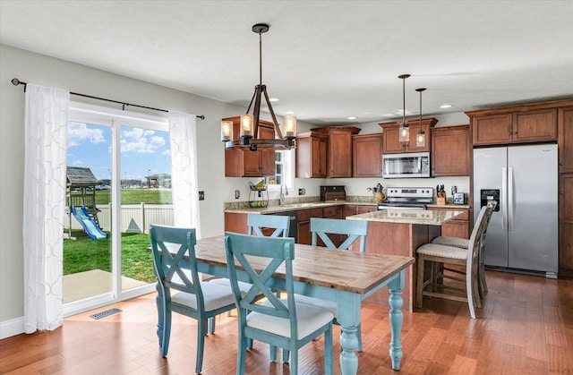 31 Lodge Trl, Monticello, IL 61856 - kitchen with stainless steel appliances, wood finished floors, a kitchen island, recessed lighting, and pendant lighting