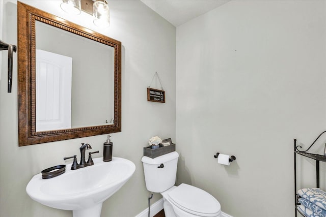 31 Lodge Trl, Monticello, IL 61856 - half bath featuring a sink, baseboards, and toilet