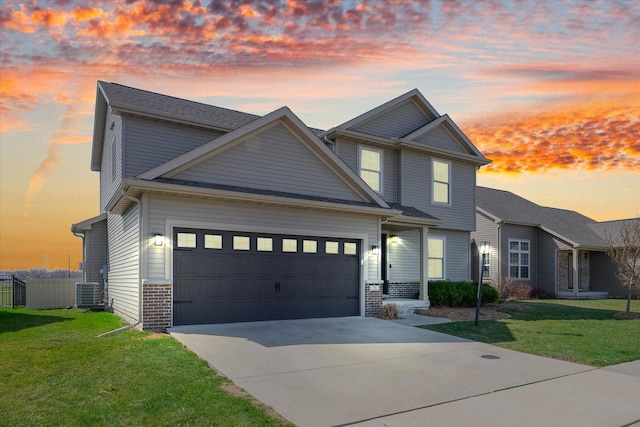 31 Lodge Trl, Monticello, IL 61856 - view of front of home with concrete driveway, central air condition unit, a garage, and brick siding
