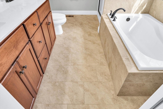 31 Lodge Trl, Monticello, IL 61856 - full bath featuring a bath, toilet, vanity, baseboards, and tile patterned floors