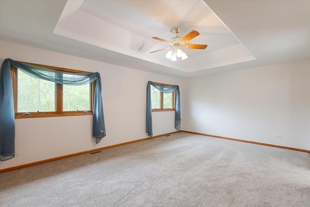2261 E Gaisor Dr, Crete, IL 60417 - unfurnished room with a tray ceiling, baseboards, carpet floors, and ceiling fan