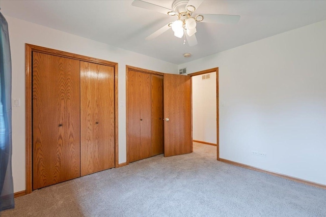 2261 E Gaisor Dr, Crete, IL 60417 - unfurnished bedroom with two closets, carpet flooring, baseboards, and a ceiling fan