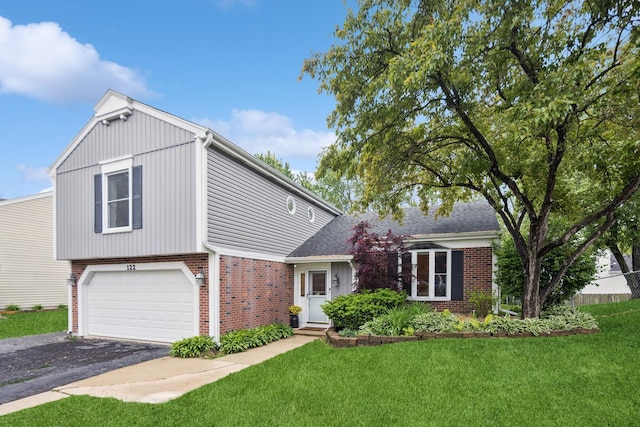122 E Sherman St, Bartlett, IL 60103 - view of front of home featuring brick siding, asphalt driveway, a front yard, and an attached garage