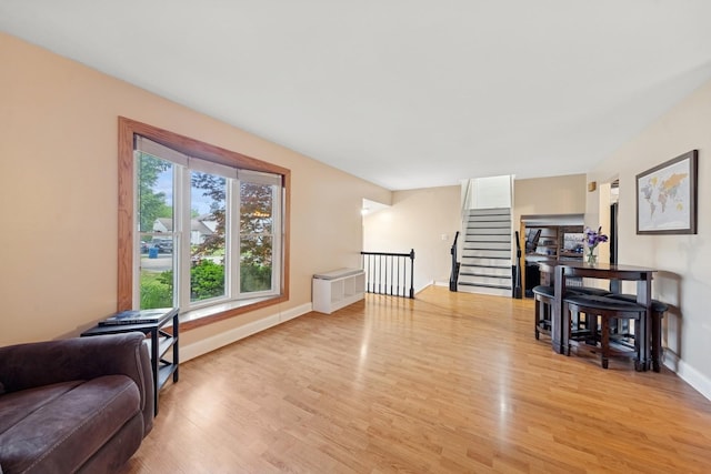 122 E Sherman St, Bartlett, IL 60103 - living room with light wood finished floors, baseboards, and stairs