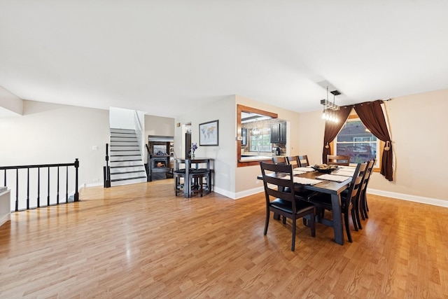 122 E Sherman St, Bartlett, IL 60103 - dining room featuring baseboards, light wood-style flooring, and stairs