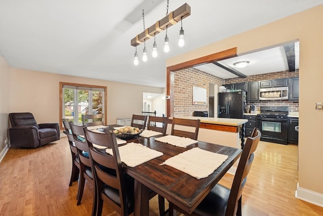 122 E Sherman St, Bartlett, IL 60103 - dining area featuring light wood-style floors and baseboards