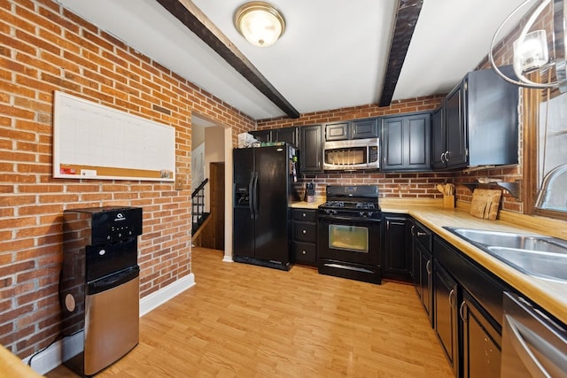 122 E Sherman St, Bartlett, IL 60103 - kitchen with black appliances, beamed ceiling, light countertops, a sink, and dark cabinets