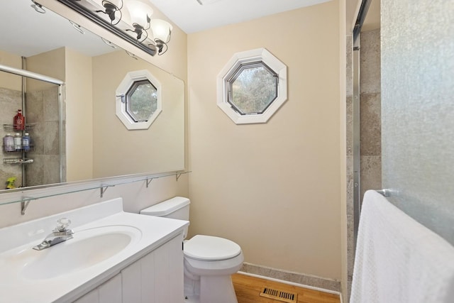 122 E Sherman St, Bartlett, IL 60103 - full bath with toilet, tiled shower, vanity, and wood finished floors