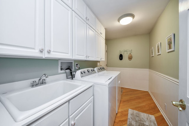 970 Brigham Way, Geneva, IL 60134 - laundry area featuring washing machine and dryer, cabinet space, a wainscoted wall, and light wood finished floors