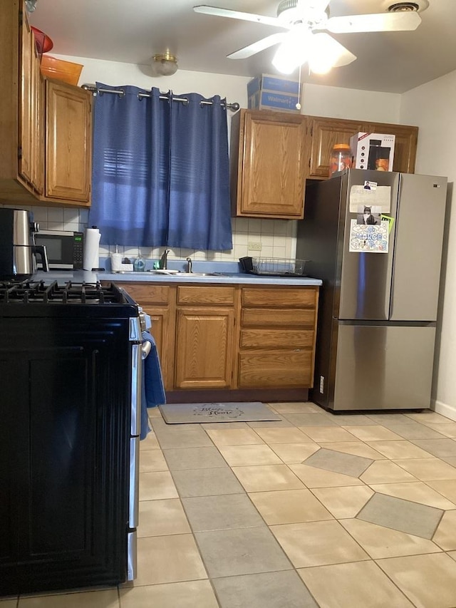 237 Marquette St, Park Forest, IL 60466 - kitchen featuring appliances with stainless steel finishes, decorative backsplash, light tile patterned floors, and a sink