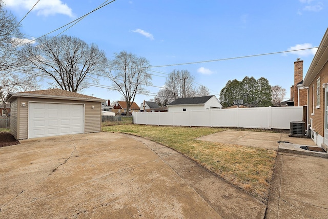 1521 N Wolf Rd, Berkeley, IL 60163 - view of yard featuring an outbuilding, driveway, central AC unit, and a detached garage