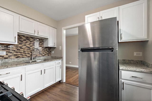 1521 N Wolf Rd, Berkeley, IL 60163 - kitchen with freestanding refrigerator, a sink, dark wood finished floors, backsplash, and white cabinets