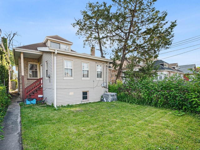 8423 S Paulina St, Chicago, IL 60620 - back of property with a yard and a chimney