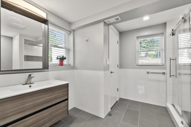 4401 Kingston Ave, Lisle, IL 60532 - bathroom with tile walls, a shower stall, vanity, a wainscoted wall, and healthy amount of natural light