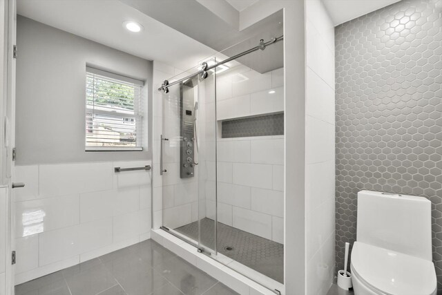 4401 Kingston Ave, Lisle, IL 60532 - full bathroom featuring tile walls, a stall shower, tile patterned floors, recessed lighting, and toilet