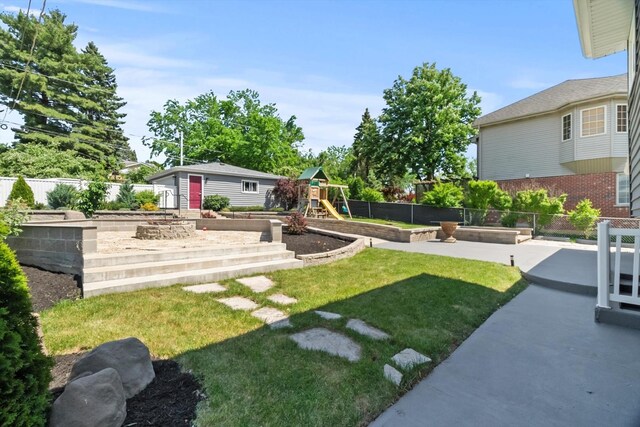4401 Kingston Ave, Lisle, IL 60532 - view of yard featuring a vegetable garden, a playground, and an outbuilding